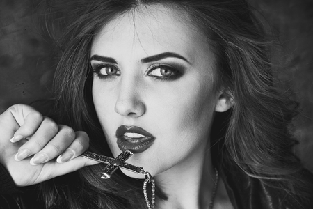 black and white photo of female models with a crossの写真素材