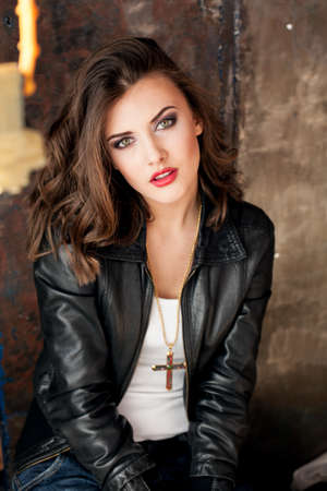 model girl sits with a cross pendantの写真素材