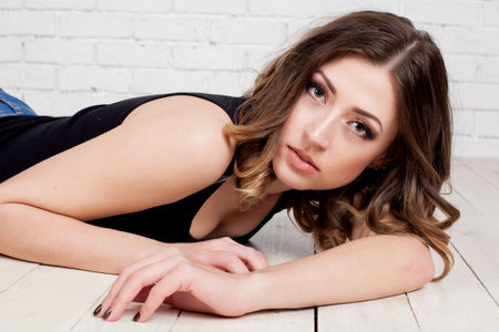 girl model rests on wooden floorの写真素材