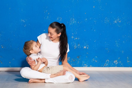 Mother plays with little boy in studioの写真素材
