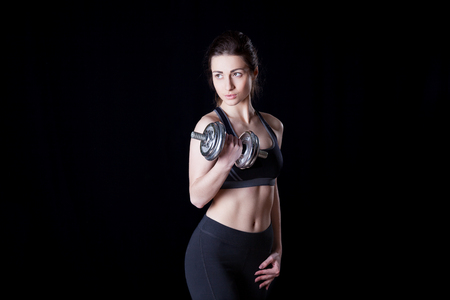 athletic woman girl with dumbbells sport trainingの写真素材
