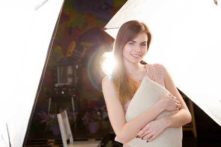 the girl with a pillow in a Photo Studioの写真素材