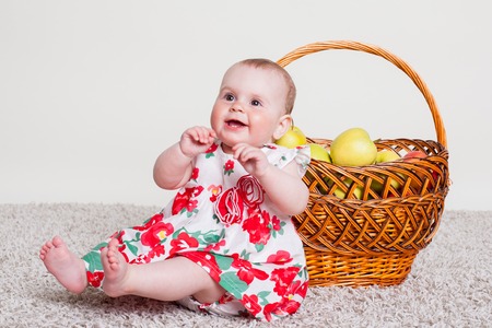 a little kid with a basket with applesの写真素材