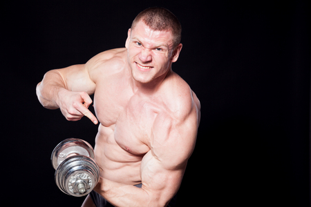 male man bodybuilder with dumbbells power workoutの写真素材