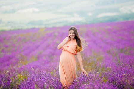 pregnant girl goes on a lavender fieldの写真素材