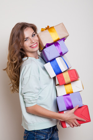 the girl stands with gifts and smilesの写真素材