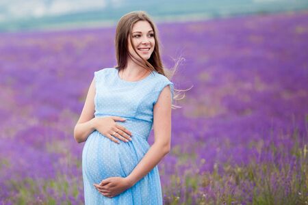 pregnant nice girl in a lavender fieldの写真素材