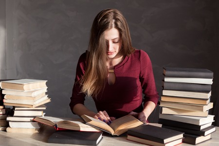 the girl sitting behind the books and readsの写真素材