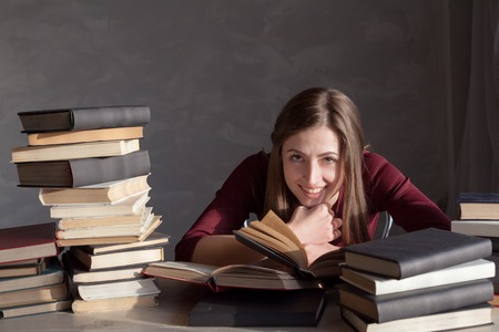 the girl sitting behind the books and readsの写真素材