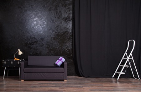 Photo Studio black wall background with sofaの写真素材