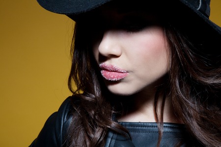 the girl in the hat posing in the Studioの写真素材