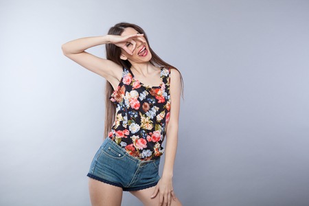 girl shows OK white young people backgroundの写真素材