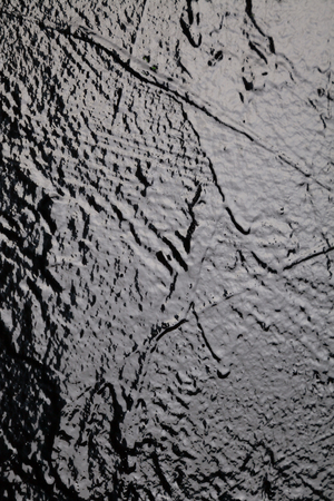 black textured wall in studio background wall textureの写真素材