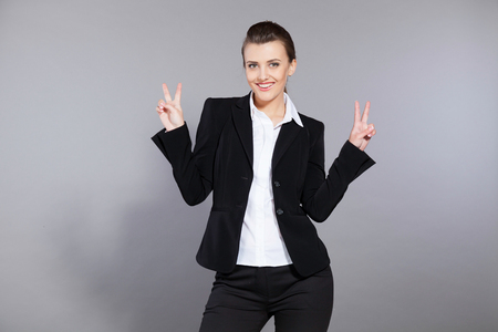 girl showing victory female smile person signの写真素材