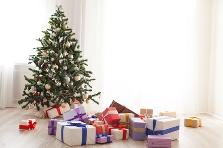 Christmas tree lots of gifts in a bright room xmasの写真素材