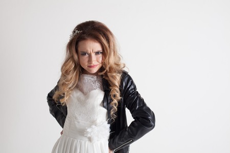 bride in white dress and leather jacketの写真素材