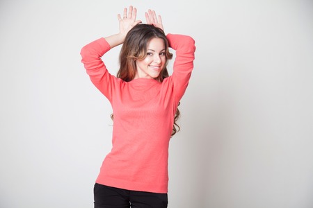 beautiful girl shows hands Hare earsの写真素材