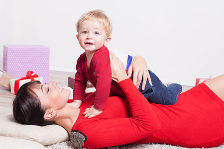 mom and young boy son play in the roomの写真素材