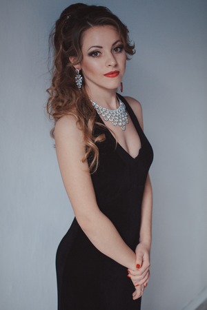 beautiful girl in black evening dress cocktail partyの写真素材