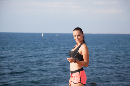 Fitness Sports girl listens to music with headphonesの写真素材