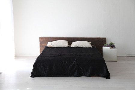 Interior white spal'nti bed with black linenの写真素材
