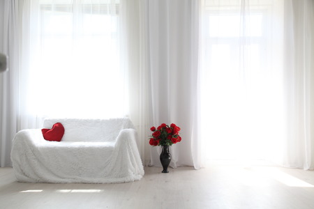 Interior white room sofa flowers light from the windowの写真素材