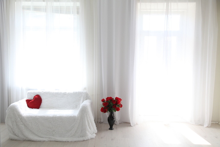 Interior white room sofa flowers light from the windowの写真素材