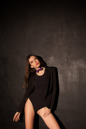 sexy girl in underwear and jacket is black wall