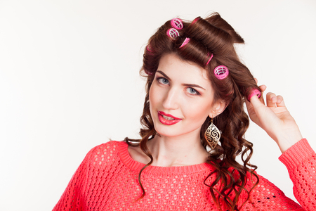 girl with curling irons makes hair styleの写真素材