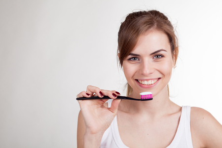 girl holding a toothbrush smilesの写真素材