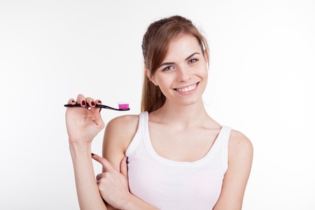 girl shows the finger on the toothbrush smile teethの写真素材