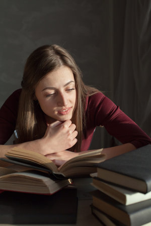 girl reading book prepares for the exam in the library
