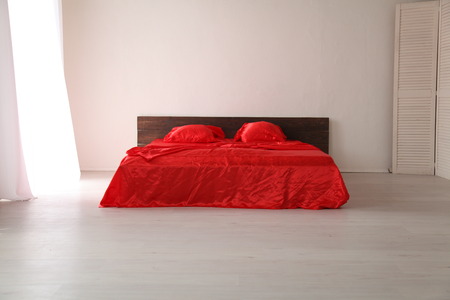 the Interior of the white room with a bed with redの写真素材