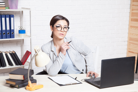 business woman in an Office works at the computerの写真素材