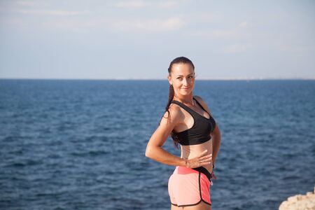Sports girl is engaged in fitness on the beachの写真素材