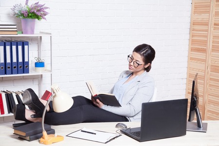 business girl works at a computer in the Officeの写真素材