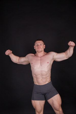 Sport the athlete bodybuilder shows off his musclesの写真素材