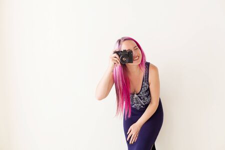 girl with pink hair photographs cameraの写真素材