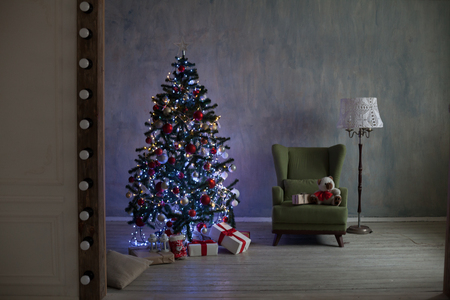 Christmas tree with lights and garlands and gifts home for Christmasの写真素材