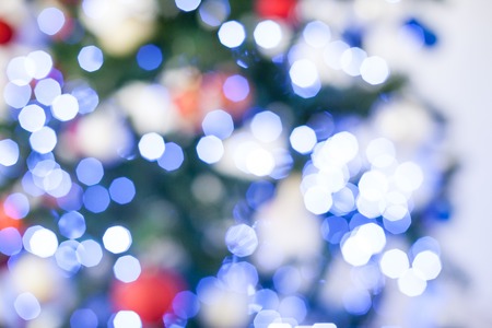 Bokeh Christmas tree with red gifts in the white room Christmasの写真素材