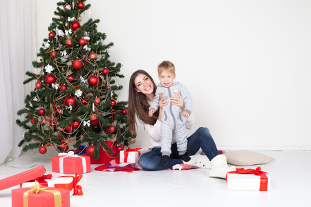 mother and son open gifts on Christmas and new yearの写真素材
