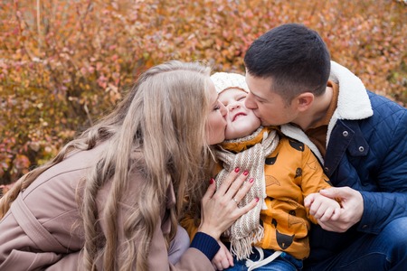 family to boys walk on autumn Woodsの写真素材