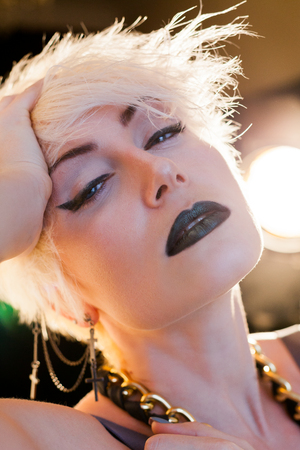 blonde girl with short hair posing fashionの写真素材