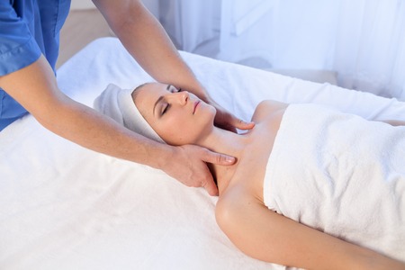 doctor cosmetologist doing facial massage girl spa treatmentsの写真素材