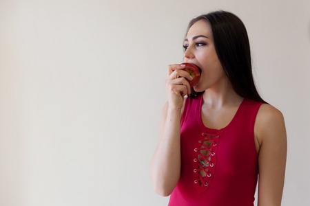 the girl happily eats ripe Appleの写真素材