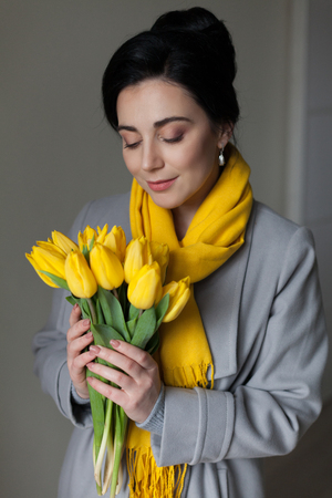 the girl gave the spring yellow tulipsの写真素材