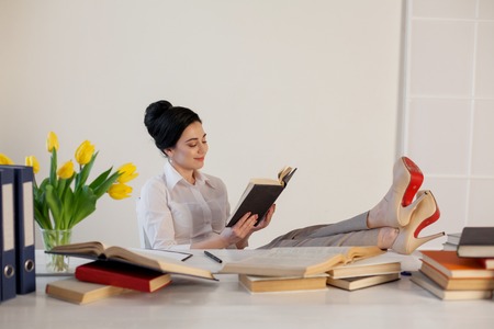beautiful girl reads books at the table preparing for the examの写真素材