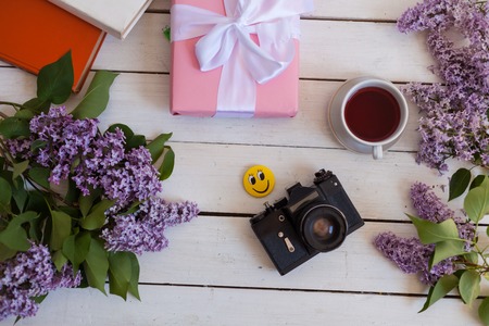 on the white table lilac, gift, notebook, cup of tea 1の写真素材