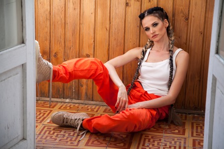 woman with long braids listens to music and dancesの写真素材