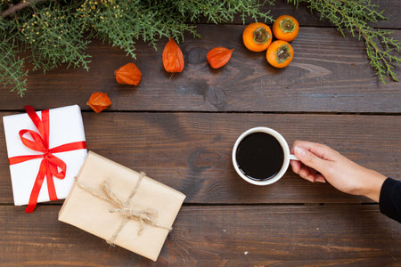 Christmas branch gift coffee cup in hand Christmas background Christmasの写真素材